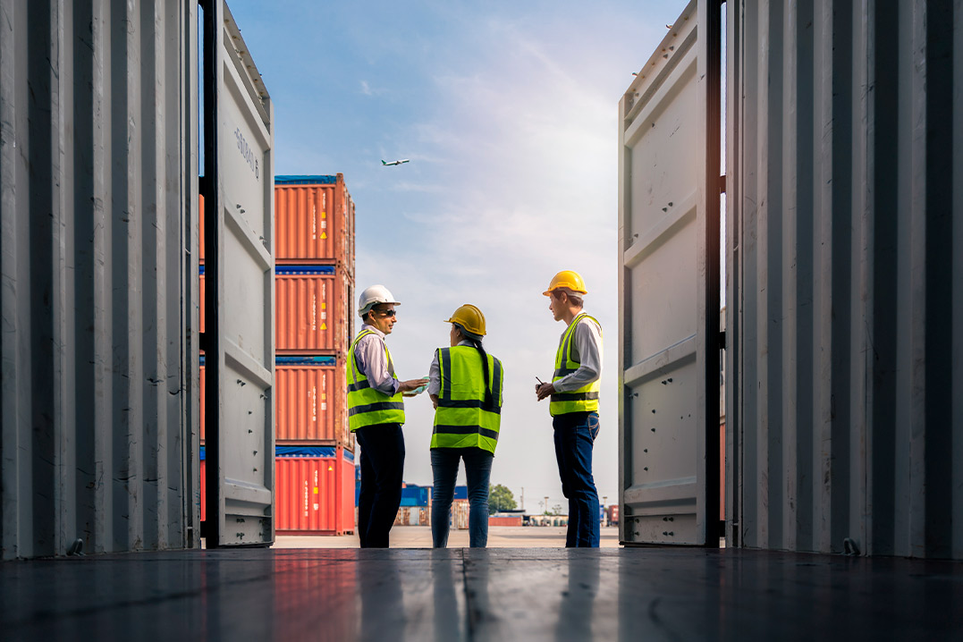 storage workers with safety uniform talking each  other