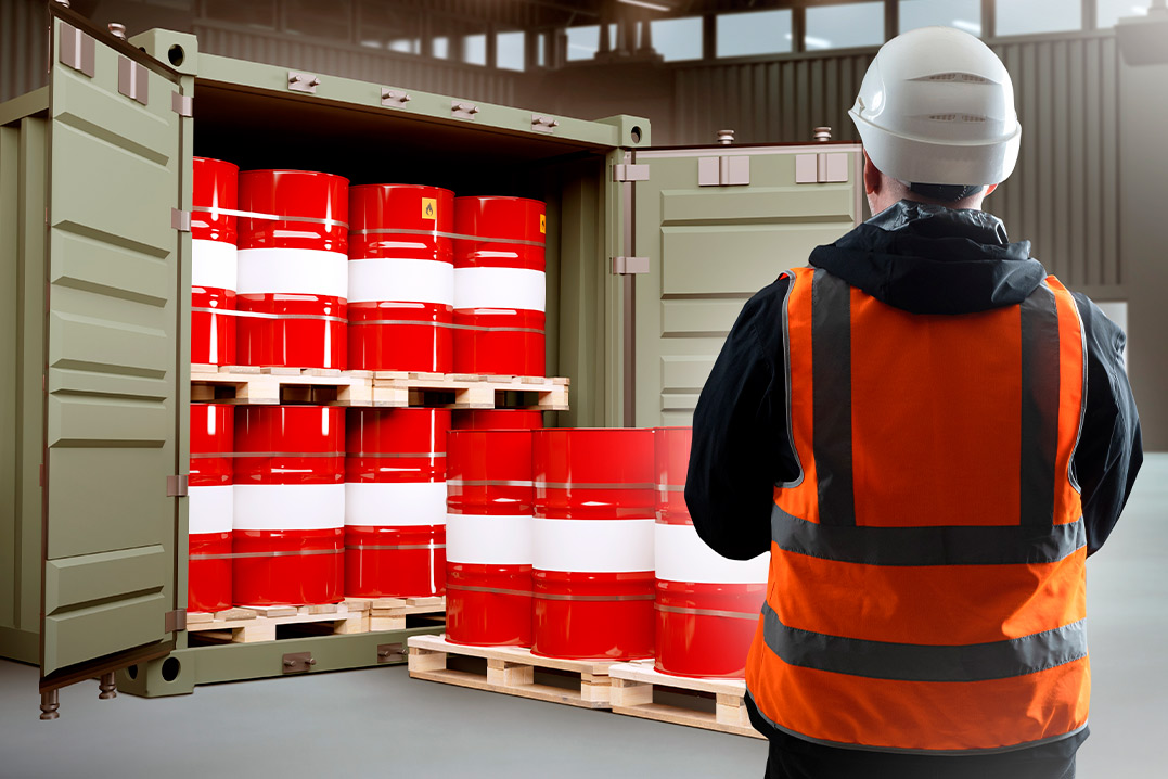 A man wearing an orange vest and hard hat examines barrels, emphasizing key tips for buying shipping containers in Texas.