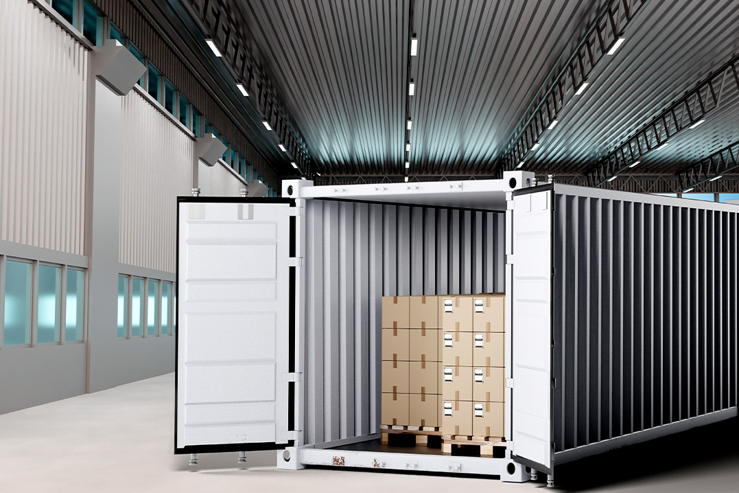 A large shipping container is open inside a warehouse, showcasing its spacious interior and storage potential.