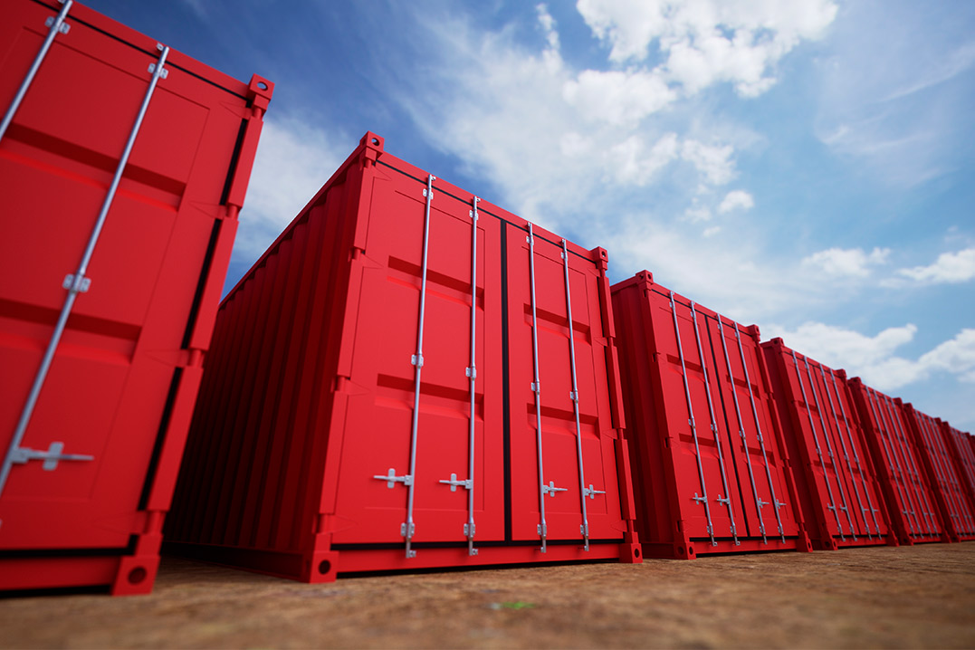 A row of red shipping containers lined up, showcasing modern storage solutions for businesses.