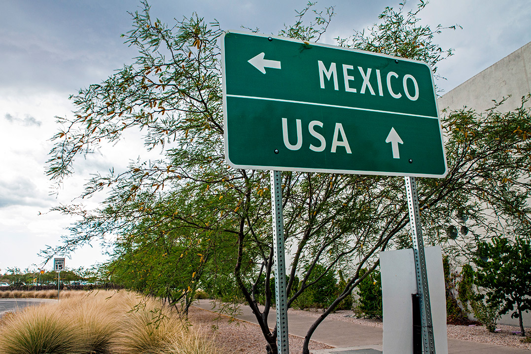Directional sign pointing to the USA and Mexico, highlighting the importance of third-party logistics in McAllen.