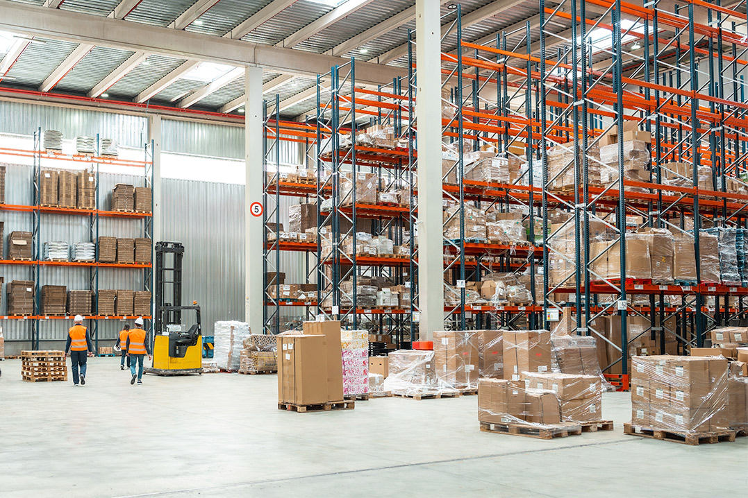 Interior view of a warehouse stacked with pallets and boxes, emphasizing duty-free warehousing options in McAllen.