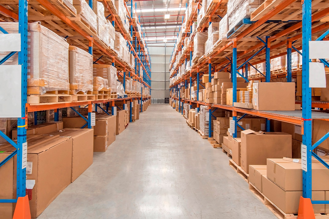  Interior view of a warehouse showcasing numerous boxes and shelves, highlighting the benefits of bonded warehousing.