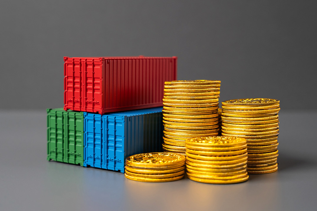 Coins stacked next to containers, symbolizing how bonded warehousing can minimize tariffs and shipping delays.
