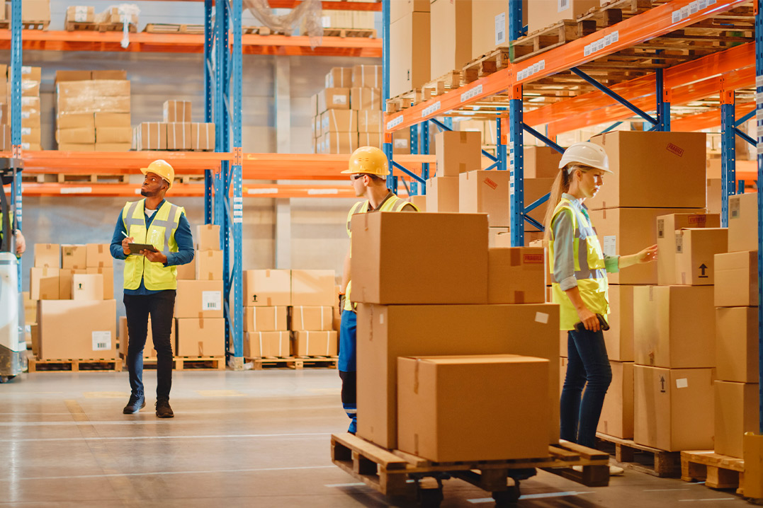 Several workers in a warehouse setting, engaged in various tasks related to 3PL services in Edinburg, TX.