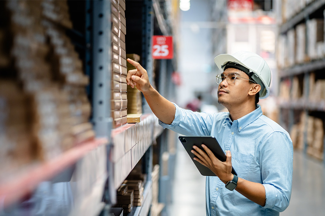  Warehouse scene featuring a man with a tablet, discussing the function of bonded warehouses for importers.