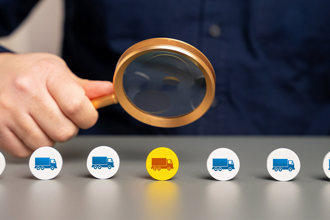 A man studies a magnifying glass featuring icons that represent bonded warehouses versus foreign trade zones.