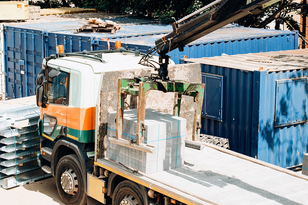A truck next to a building, advertising metal storage containers for rent during the spring construction season.