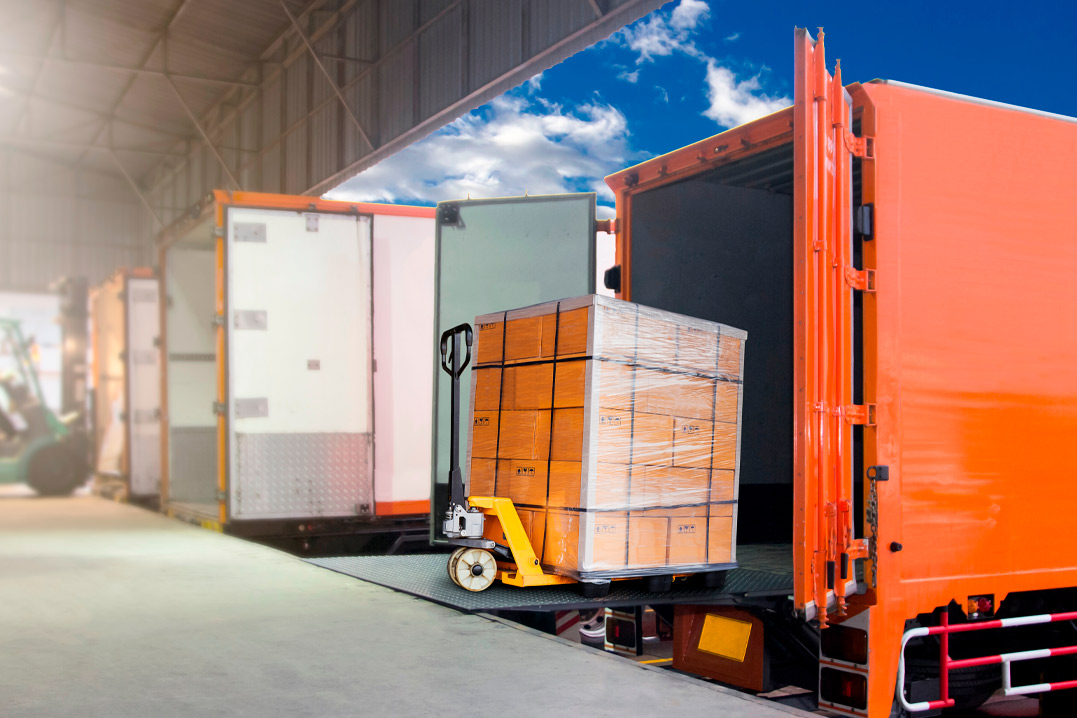 Packaging Boxes on Pallet Loading into Shipping Cargo Container. Delivery Trucks. Supply Chain. Trucks Parked Loading at Dock Warehouse. Shipment. Cargo Freight Truck Transport Logistics.