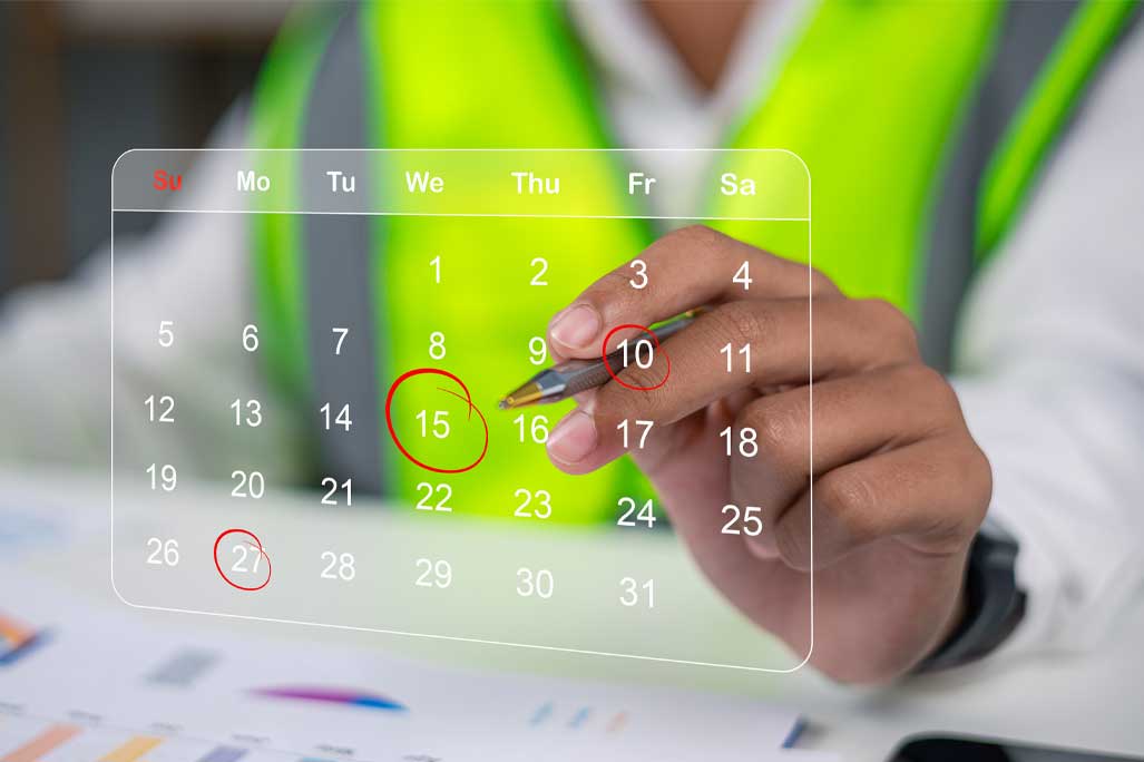 Professional logistics worker in safety vest using digital calendar to plan delivery shipment. Concept of supply chain management, distribution schedule, and warehouse transportation.