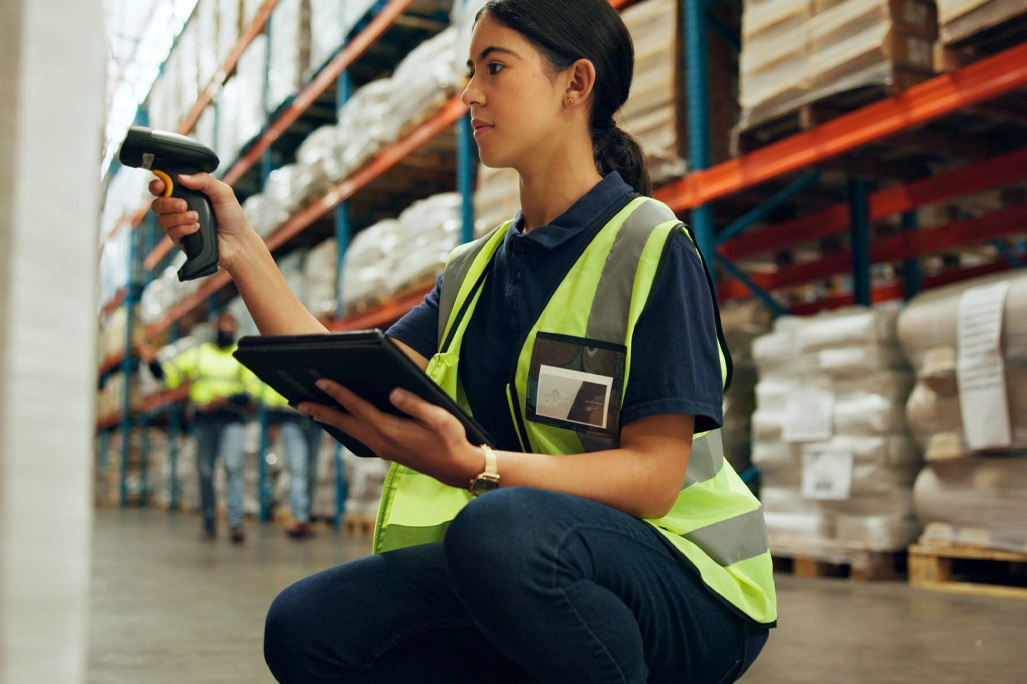 Tablet, woman and scanner at warehouse for inventory, check stock or smart storage system at shelf. Technology, engineer and barcode reader for cargo inspection, logistics app or shipping at factory