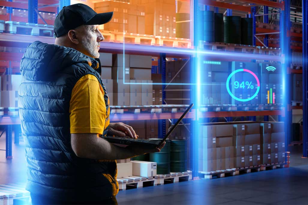 Man warehouse supervisor. Storage manager holding laptop. Man uses warehouse technology. Concept of using software to record goods for storage. Supervisor near shelves with boxes. Warehouse audit