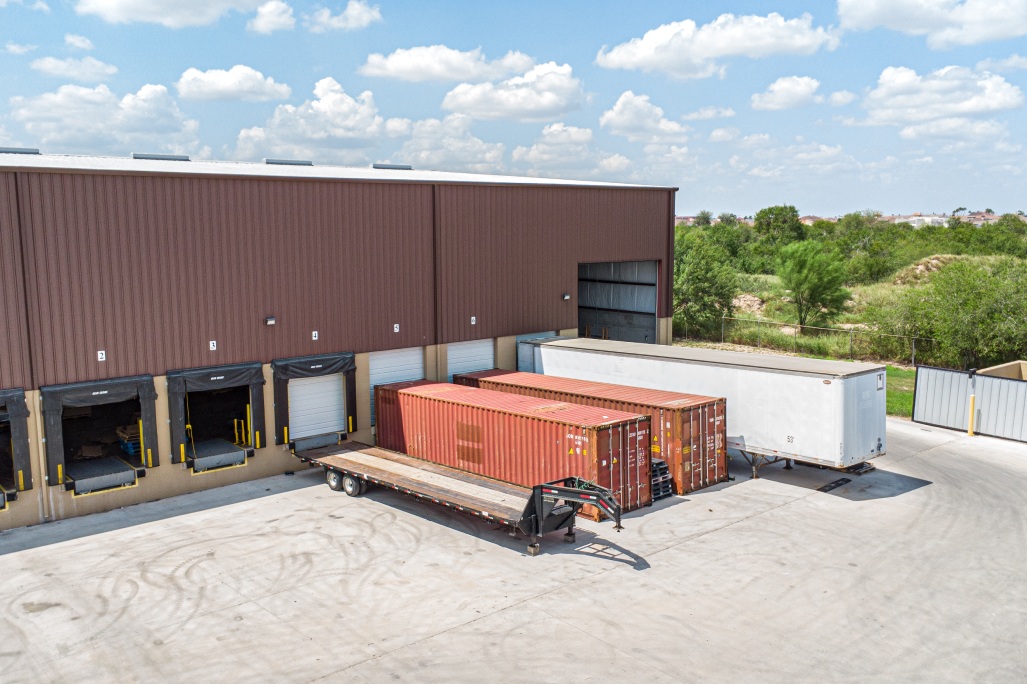 CTC warehouse with two trucks parked outside, illustrating a 3PL bonded warehousing facility.